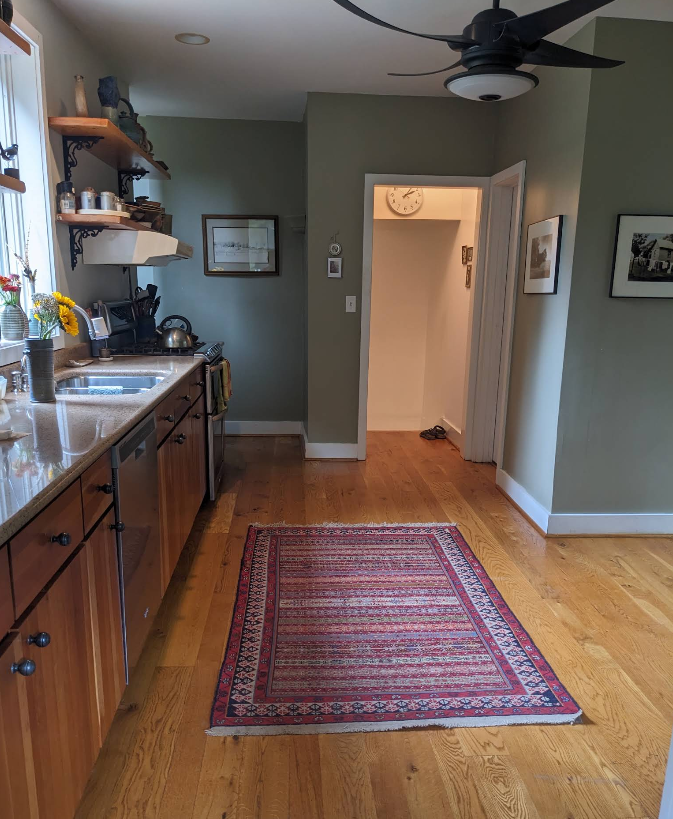 Bright kitchen hallway with polished hardwood floors and dust-free cabinetry after cleaning in Rochelle IL