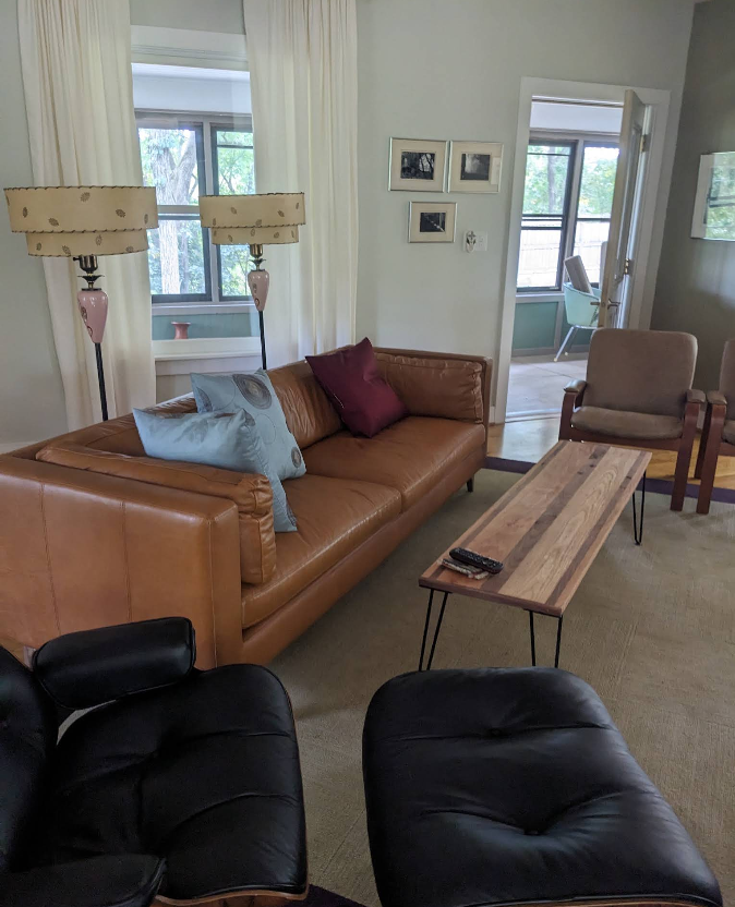 Spotless living room with leather sofa, coffee table, and freshly vacuumed carpet in Rochelle IL
