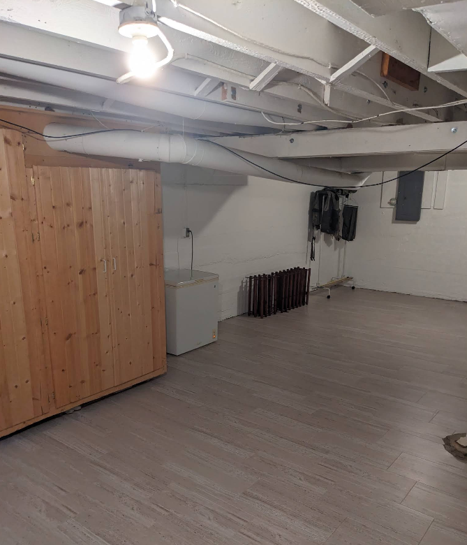 Finished basement with dust-free floors and organized storage after deep cleaning in Rochelle IL