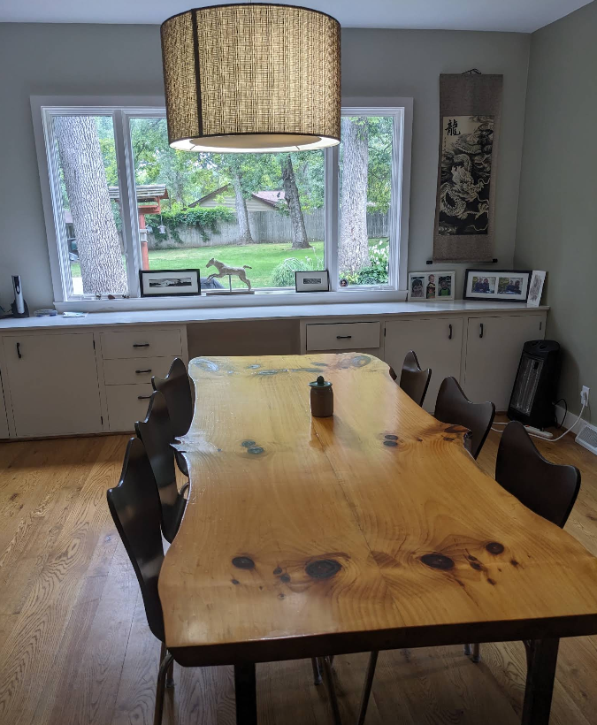 Dining room with live-edge wood table, dust-free windows, and polished floors in Rochelle IL
