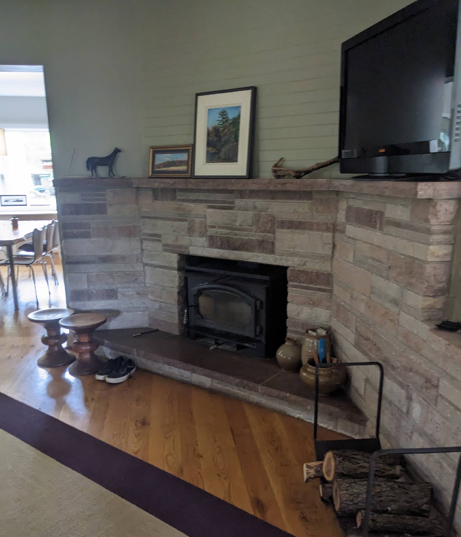 Cozy family room with fireplace, mantle, and clean hardwood floors after residential cleaning in Rochelle IL
